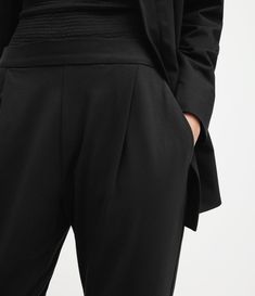 Tailoring for everyday. The Aleida Pants are a crowd favourite. Crafted from a comfortable jersey fabric. They're shaped to a mid-rise silhouette with a tapered leg.     Mid-rise Side pockets Back pockets Pleat from the waist Elasticated waistband Jersey Trousers, Leather Heels Sandals, Jersey Pants, Pants And Leggings, New T, Sleeveless Tank Top, All Saints, Pants Black, Sleeveless Tank