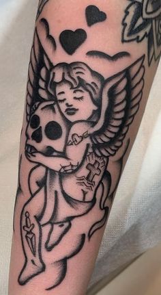 a black and white tattoo with an angel holding a koala on it's arm