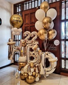 a large number made out of balloons in front of a door