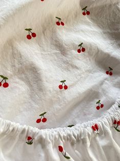 a white sheet with cherries on it