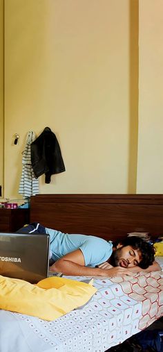 a person laying in bed with a laptop