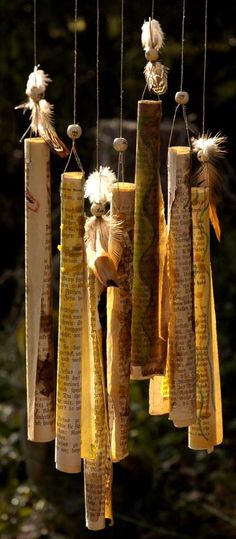 an old book page wind chime hanging from strings