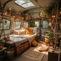 a camper van is decorated with plants and pillows for the bed area, as well as other decorations