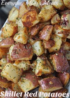 a white plate topped with potatoes covered in seasoning