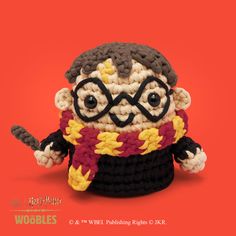 a crocheted harry potter doll with glasses