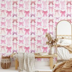 a bedroom with pink wallpaper and a mirror