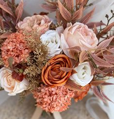 a bridal bouquet with peach and white flowers