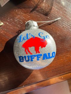 Buffalo bills design ornament. Custom made for each order. Returns only accepted if item arrives damaged Ornament Diy, Buffalo Ny, Buffalo Bills, Glitter Christmas, Christmas Tree Lighting, Perfect Christmas Gifts, Christmas Ornament, Circuit, Ornament Decor