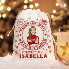 a drawsack bag sitting on top of a table next to a christmas tree with lights in the background