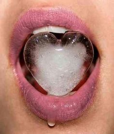 a woman's lips with a heart shaped mirror in the middle of her mouth