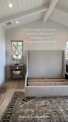 a large bed sitting inside of a bedroom on top of a rug