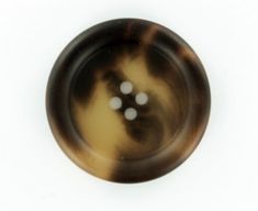 a brown and black button with white dots on the center is seen in this image