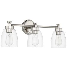 three light bathroom fixture with clear glass shades on the sides and chrome finish, in an old - world style