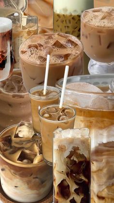 there are many different types of drinks on the table with ice cream and coffee in them