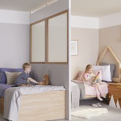 two children are sitting on their beds in the same room