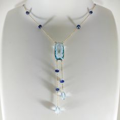 **KINDLY CHECK OUT THE VIDEO OF THE ITEM FOR A CLEARER VIEW**Details of the Necklace: Length of necklace is 16 inches. Other sizes available on request. Gemstone : Sky Blue Topaz Gemstone shape, size and weight- cushion , 20x10mm,10.08 carats Blue sapphire beads-3mm, 9ec,5.55 carats Sky blue topaz drops-7x5mm,3.25 carats, 2 pec Total Gemstone weight: 18.88 carats Metal: GOLD Purity: 14K (58.33%)approx Gold Weight: 1.63 grams Total weight: 5.41 grams Aunthtic sky Blue Topaz cushion, blue sapphire Sapphire Beads, Blue Sapphire Necklace, Handmade Gold Jewellery, 16 Inch Necklace, Blue Topaz Necklace, London Blue Topaz Ring, Yellow Gold Jewelry, Sky Blue Topaz, Gold Necklaces