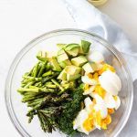 a glass bowl filled with different types of vegetables