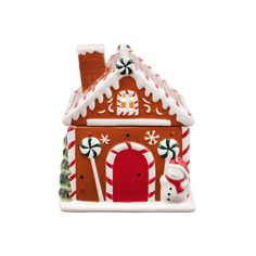 a ceramic gingerbread house ornament with candy canes and snowflakes