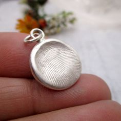 Solid Silver Fingerprint Impression Kit - One Pendant Approximately 18mm diameter, size varies. Finished pendant weighs approximately 5 grams This kit creates a Small Solid Sterling Silver Fingerprint Pendant. Optional Chains Available. These beautiful, one of a kind pendants are created in person from your loved ones' actual fingerprints. These are ideal for infants to children up to 10 years old. Adults prints will work also, they tend to be flatter, without a ridge or border but are still beautiful. HOW IT WORKS 1. Order this and we quickly send you a kit with complete instructions on how to take impressions from anyone's actual finger, thumb or toe. 2. Return the impression to us using your preferred shipper. 3. We make them into precious keepsake jewellery and send them back to you! ( Finger Print Necklace, Thumbprint Pendant, Fingerprint Pendant, Thumbprint Jewelry, Thumb Print, Fingerprint Necklace, Thumb Prints, Finger Print, Fingerprint Jewelry