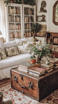 a living room filled with lots of furniture and books on top of a coffee table