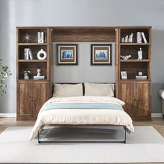 a bed sitting in a bedroom next to a book shelf filled with books and pillows