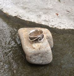 "Here is a new \"spin\" on my popular \"ocean wave\" ring. My sterling silver \"ocean wave\" ring spins around a hand formed and hammered sterling silver band making a unique spinner ring. I oxidize and hand polish it to bring out the rustic beauty of the silver. Great for those who like a chunkier style ring. The spinner ring measures 3/8\" wide. I custom make each ring for you upon ordering and it will leave my workbench and be on its way to you in 2-5 days. It will arrive in a little ribbon t Spiral Sterling Silver Ring Stamped 925, Handmade Silver Wavy Jewelry, Handmade Sterling Silver Spiral Rings, Adjustable Sterling Silver Wavy Rings, Silver Wavy Jewelry For Anniversary, Wavy Silver Jewelry For Anniversary, Handmade Sterling Silver Swirl Rings, Sterling Silver Wavy Promise Ring, Sterling Silver Promise Ring With Wavy Shape