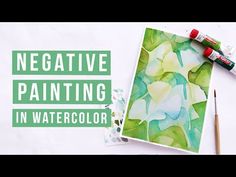 some paint and watercolors sitting on top of a white surface with the words negative painting in green