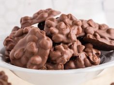 a white bowl filled with chocolate covered cookies