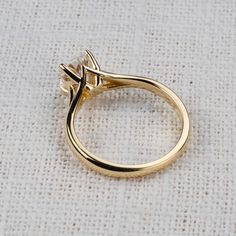 a yellow gold ring with an arrow on it