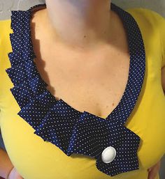 a woman wearing a yellow shirt with a blue and white polka dot bow on it