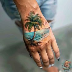 a palm tree tattoo on the left hand