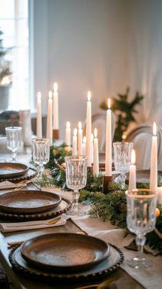 a table set with candles and place settings