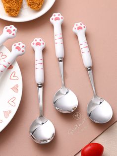 the spoons are decorated with hearts and paw prints on them, along with other utensils