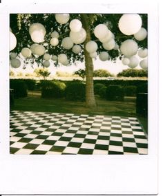 a black and white checkered floor under a tree