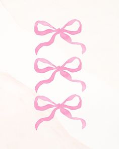 three pink bows on white paper with watercolor effect in the middle and bottom corner