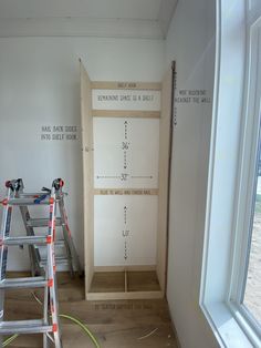 two ladders are in front of a wall that is being built into the side of a room