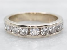 a wedding band with five diamonds on it