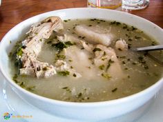 a white bowl filled with soup on top of a table