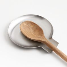 a wooden spoon sitting on top of a metal pan