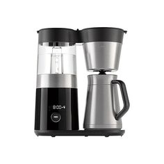 a coffee maker with two cups next to each other on a white background and one has a black lid