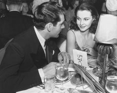 a man and woman sitting at a dinner table