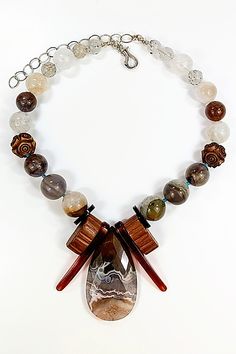 Silver & Stone Necklace - This necklace features a beautiful Coyamito agate peardrop pendant, embraced by vintage, sheer brandy-hued bakelite and molded wood bakelite. A polished study in chocolate tones and cream, it also features phantom agate, auralite 23, Victorian vulcanite beads, ghost quartz, and tourmaline quartz highlighted with Arizona turquoise. The necklace is 14 inches long with a sterling silver hinged hook clasp and a 4-inch sterling extender chain. Vintage Brown Agate Necklace, Brown Vintage Agate Necklace, Unique Brown Teardrop Necklace, Coyamito Agate, Arizona Turquoise, Hook Clasp, Stone Necklace, Silver Necklaces, Tourmaline