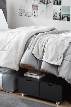 a bed sitting on top of a wooden floor next to a white wall