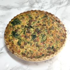 a quiche sitting on top of a marble counter