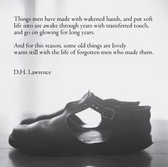 a pair of shoes sitting on top of a table next to a quote from d h lawrence