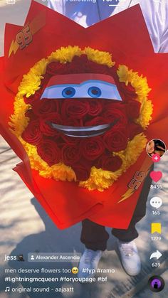 a person holding a red bouquet with yellow flowers in the shape of a sesame character