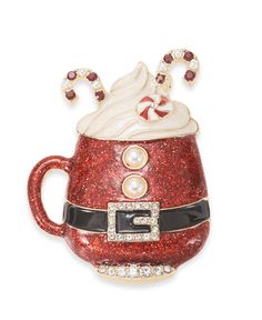 a red and white coffee cup with candy canes on it's head, decorated with swaroons