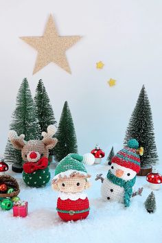 crocheted christmas decorations with snowman, reindeer and santa clause on the top