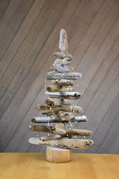 a wooden christmas tree made out of driftwood