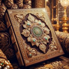 an intricately decorated gold and green box on a couch in a room with chandeliers